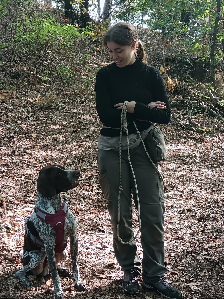 A truffle hunter and her dog in the woods near Alba