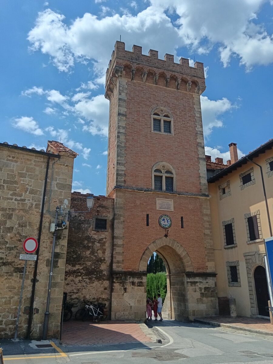 The red-brick gate tower at the entrance to the village of Bolgheri