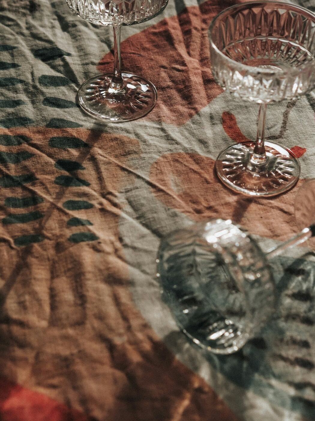 Crystal glasses on a linen tablecloth, ready for lunch