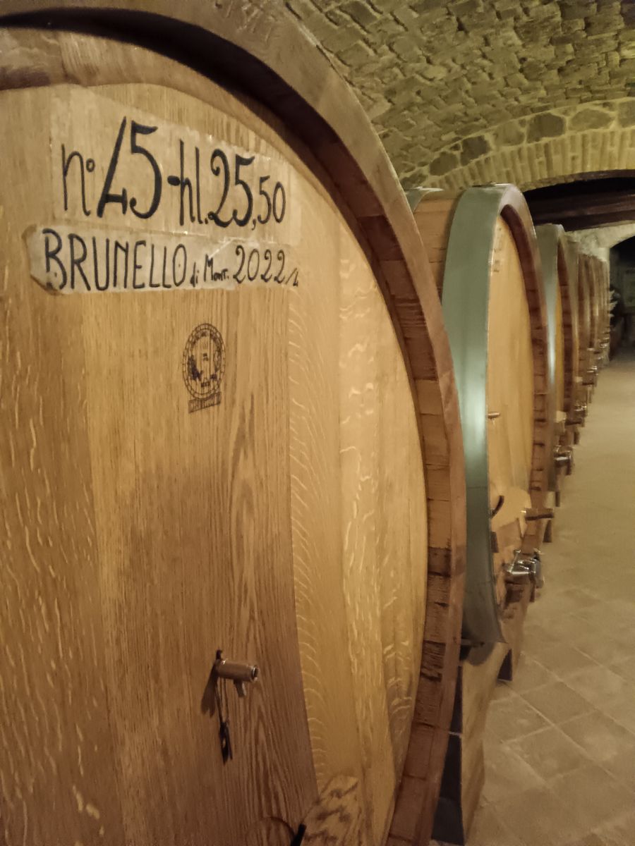Large oak casks of Brunello di Montalcino in a vaulted cellar