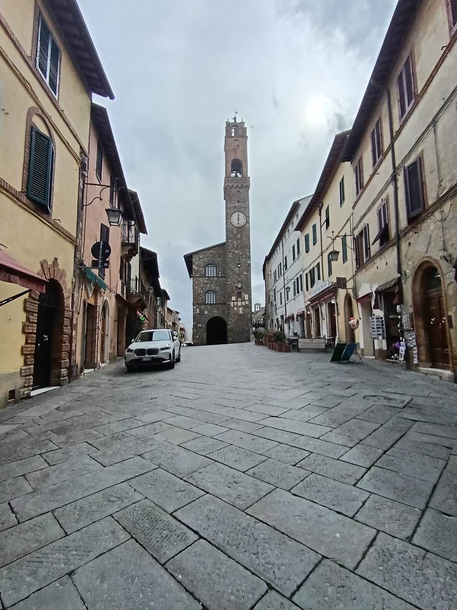Via Matteotti climbing to the Palazzo dei Priori tower in Montalcino