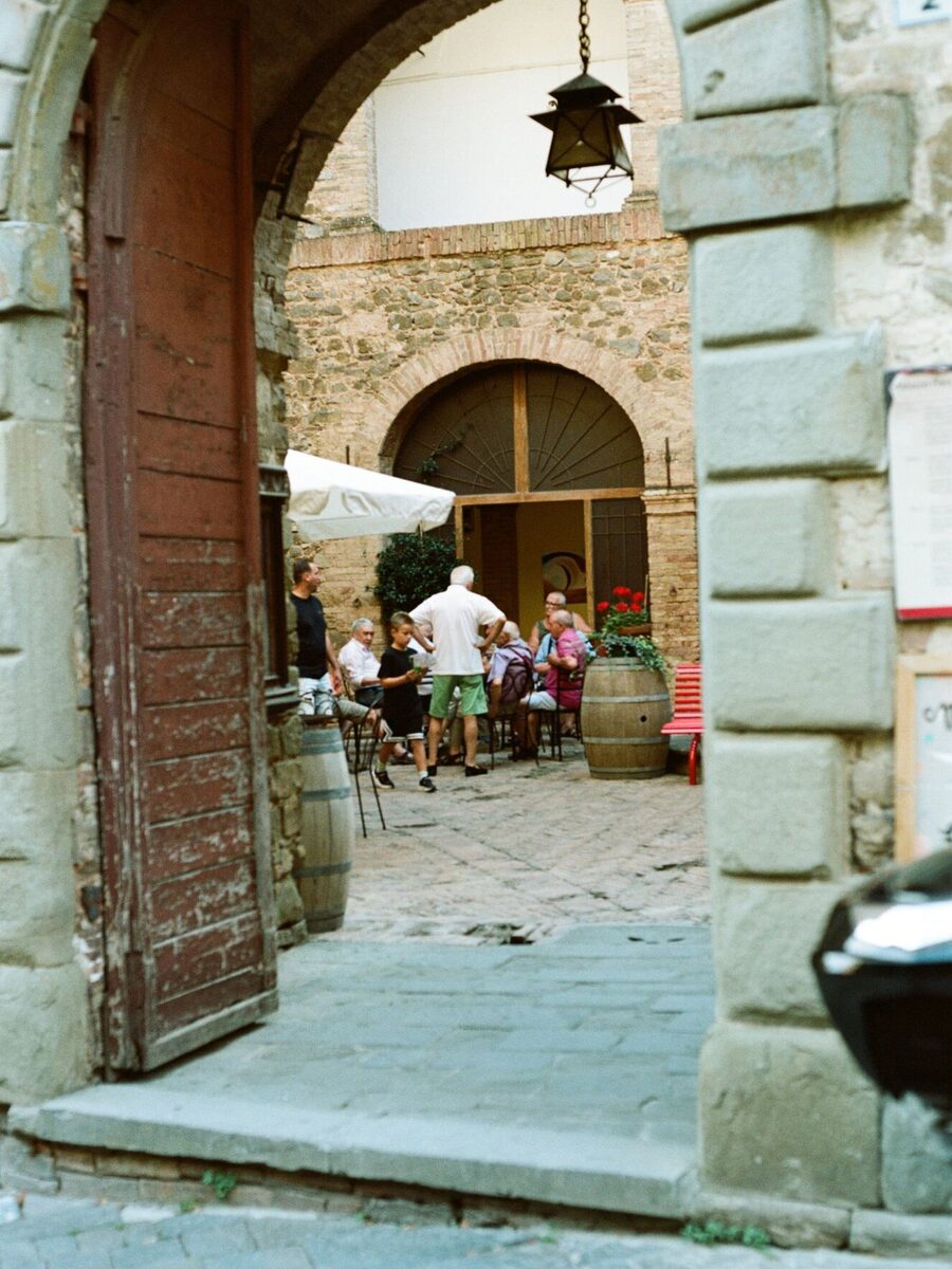 A stone archway onto a courtyard wine cellar in Montepulciano