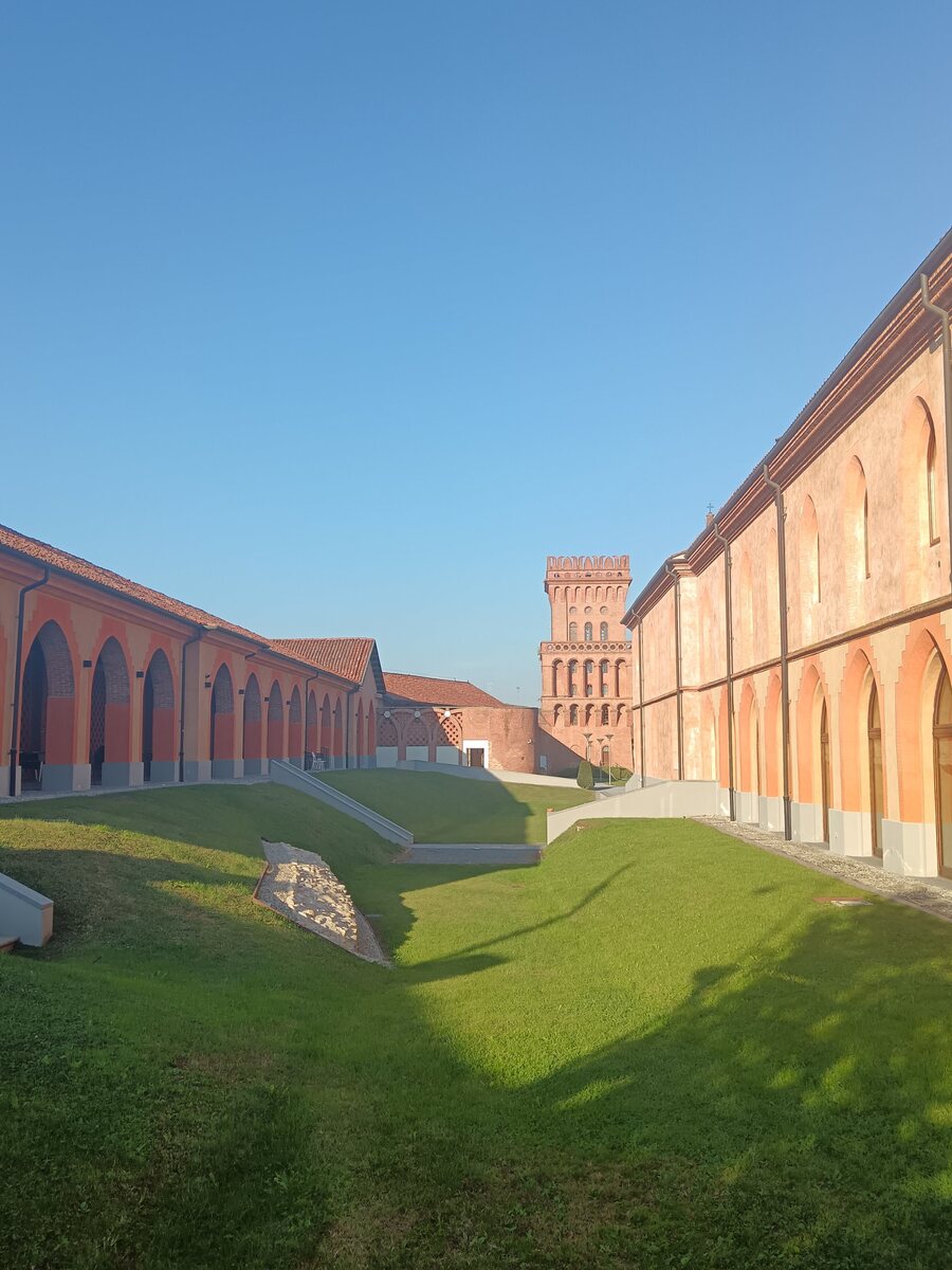 The brick arcades and tower of the Agenzia di Pollenzo