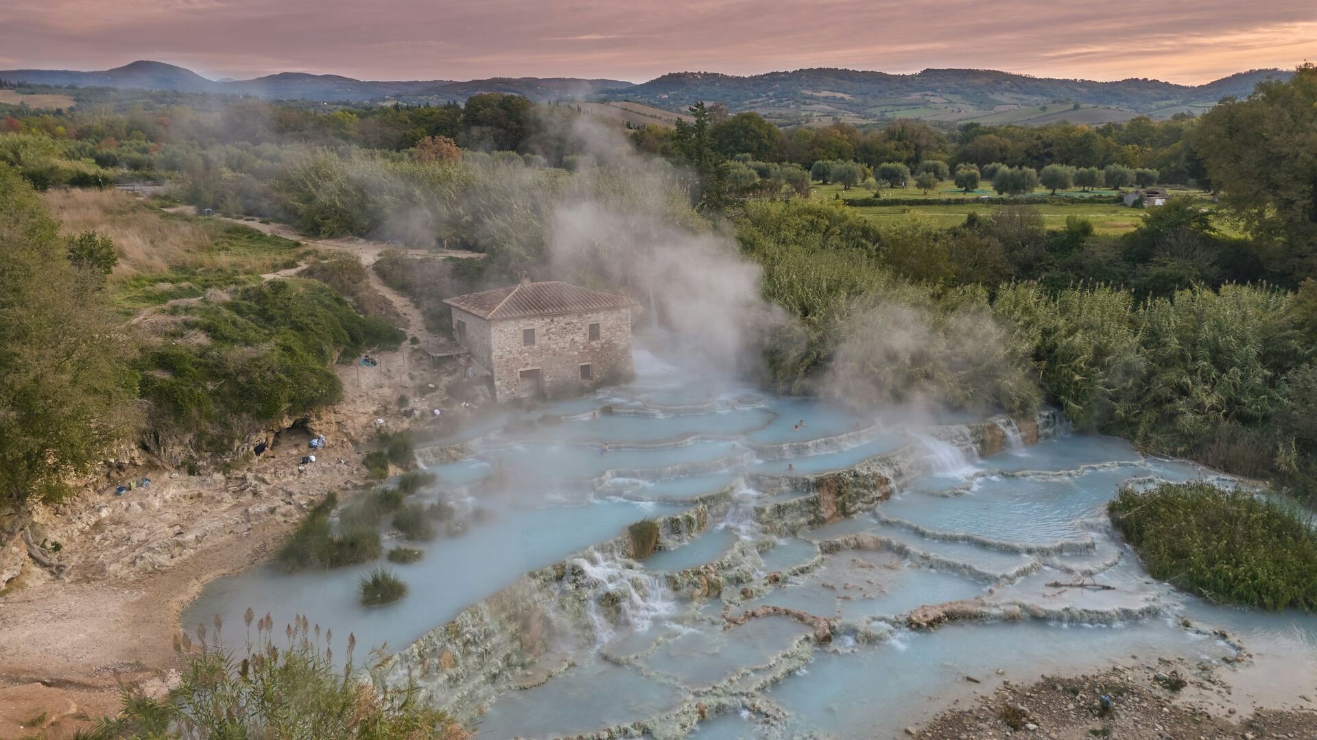 Steam rising from the thermal waterfalls of Saturnia at dawn